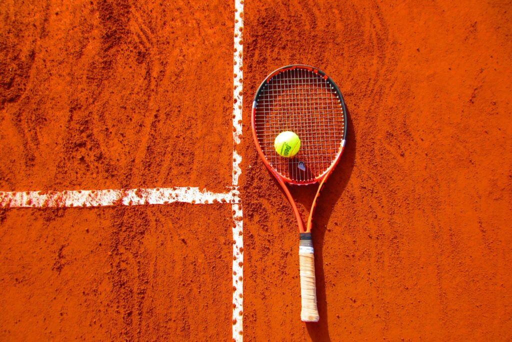 Tennis racket and ball on court